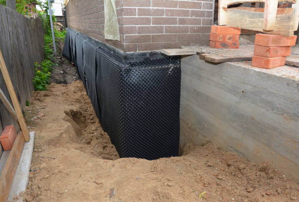 Happy homeowners after waterproofing job in Rose Hill
